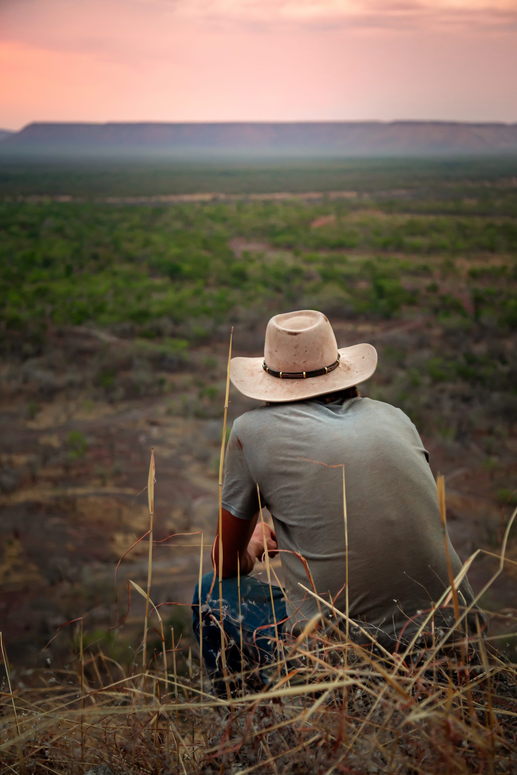 Lonely farmer watching sunset on a remote cattle station in Northern Territory, Australia
